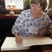 Heather Wilkinson Rojo signing the Mayflower descendants book -