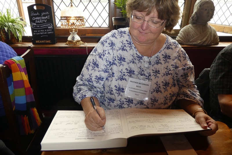 Heather Wilkinson Rojo signing the Mayflower descendants book -